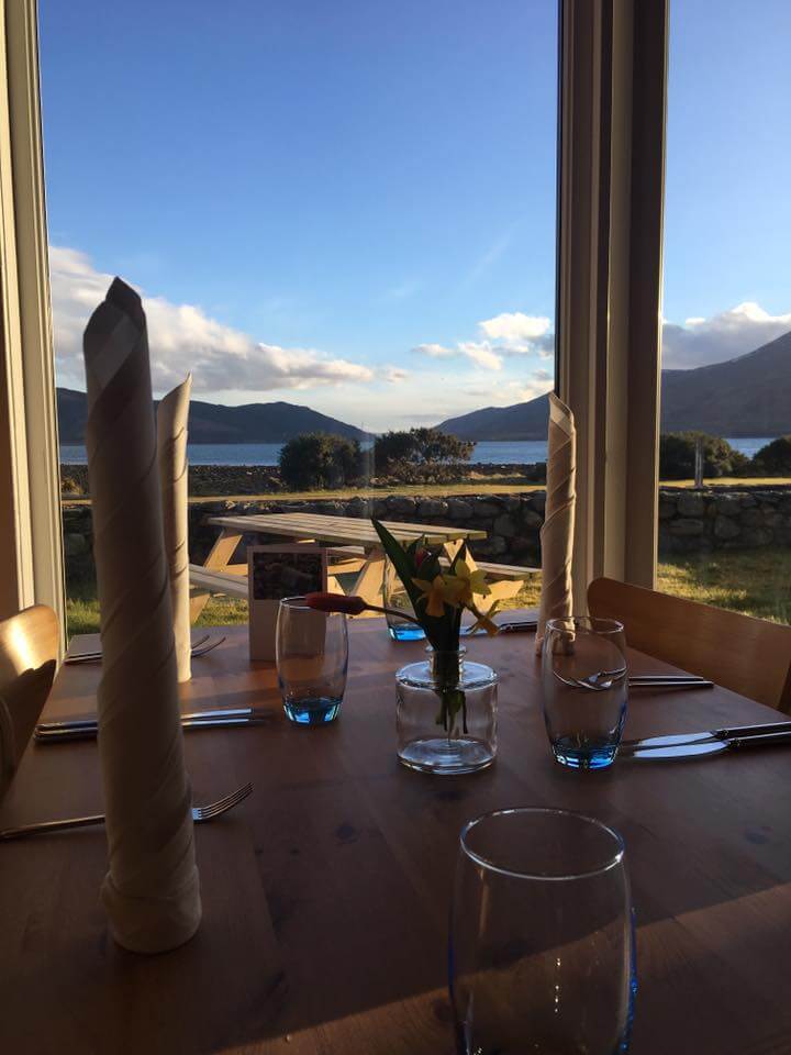 Cosy dining table with mountain and loch view, set for a relaxing meal at Balmacara.