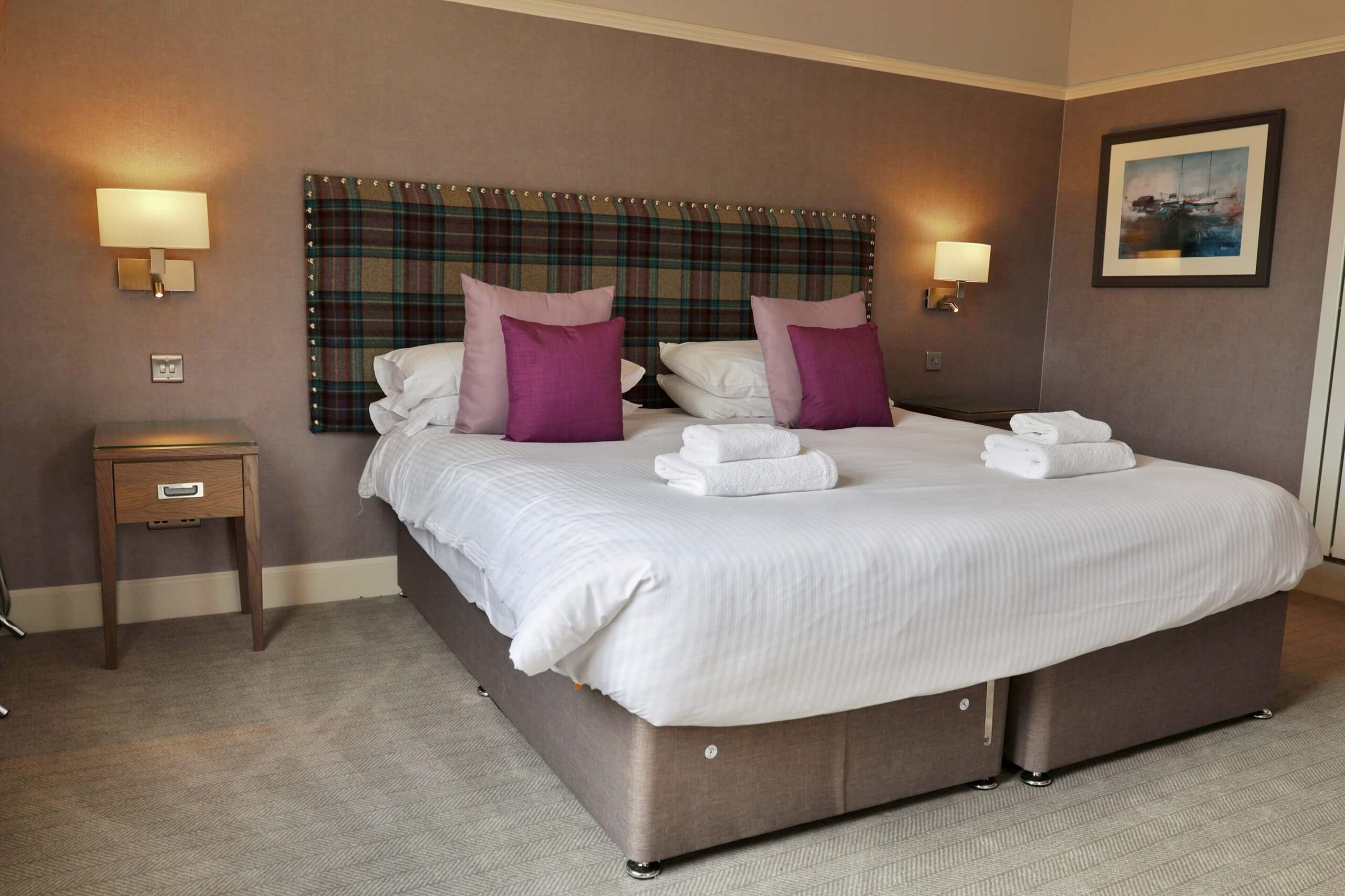 Elegant double room in Balmacara Hotel with cosy decor, plush pillows, and warm lighting.
