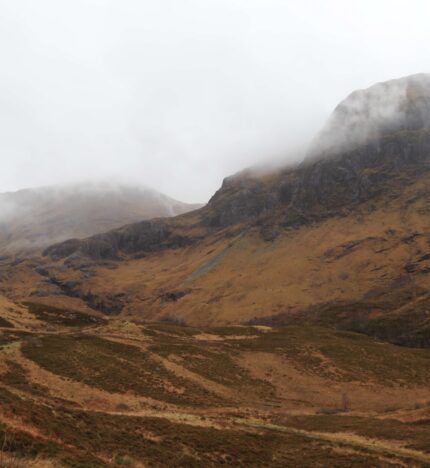Misty mountains in Balmacara provide a serene, inviting backdrop for a scenic retreat.
