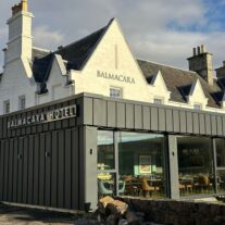 Charming Balmacara Hotel with inviting dining area, nestled in a serene countryside setting.